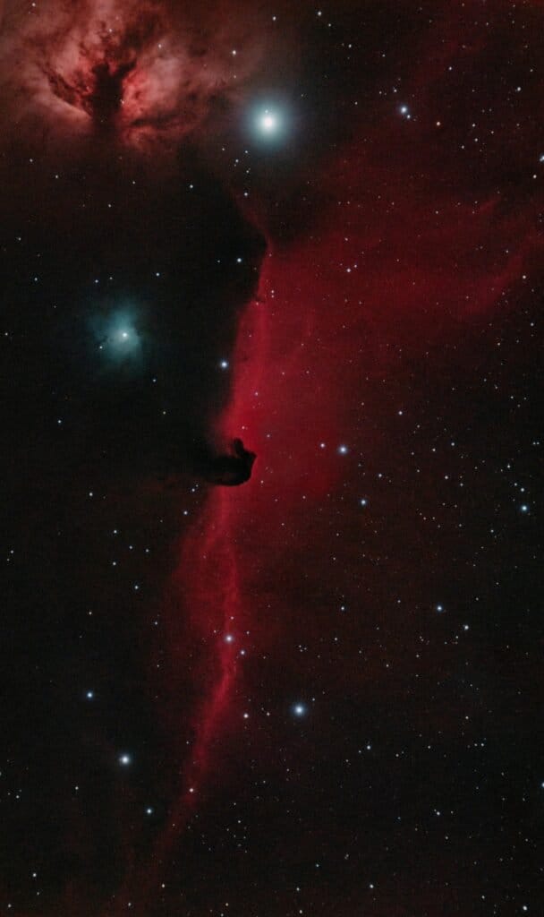 A breathtaking image capturing the vivid red hues of the Horsehead Nebula in the Orion constellation, set against a stellar backdrop.