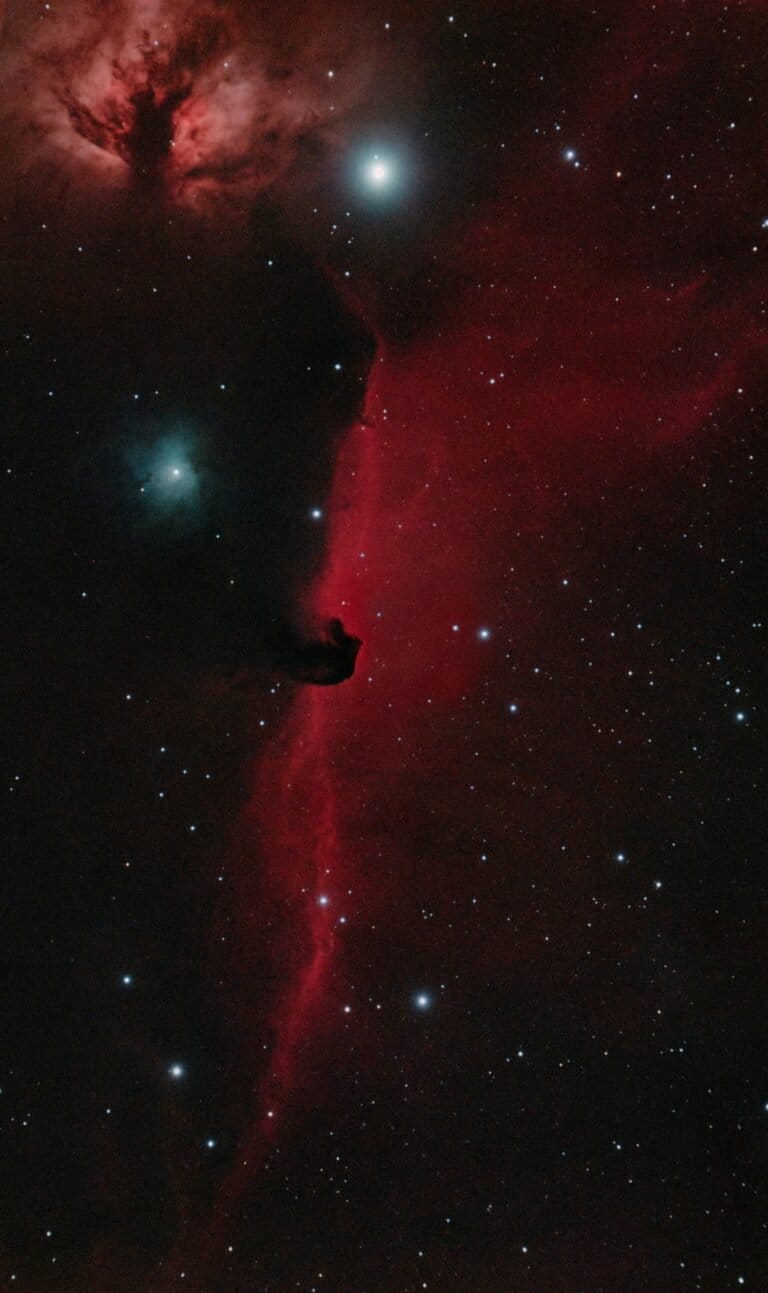 A breathtaking image capturing the vivid red hues of the Horsehead Nebula in the Orion constellation, set against a stellar backdrop.
